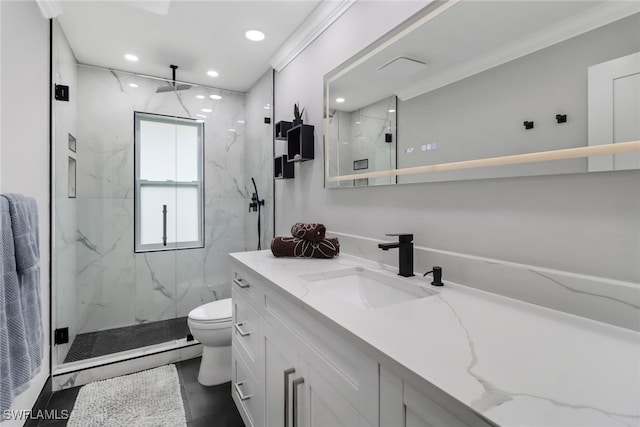 bathroom featuring vanity, crown molding, a shower with shower door, and toilet