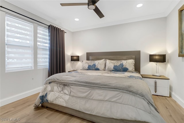 bedroom with ornamental molding, light hardwood / wood-style floors, and ceiling fan