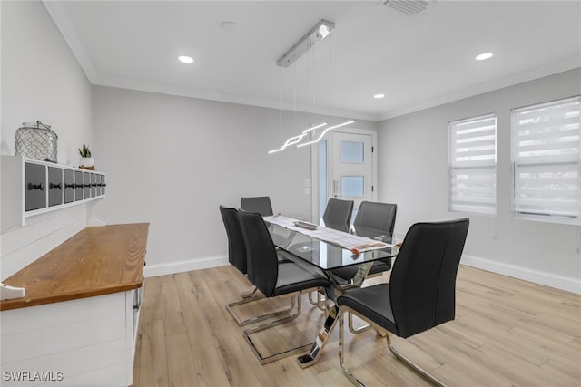 dining room featuring light hardwood / wood-style floors and ornamental molding