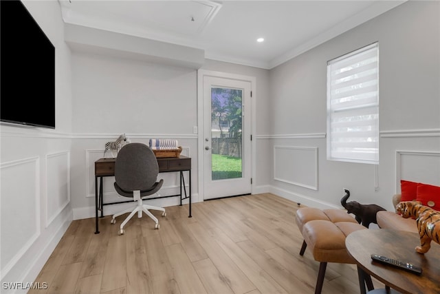 office space featuring ornamental molding and light hardwood / wood-style flooring