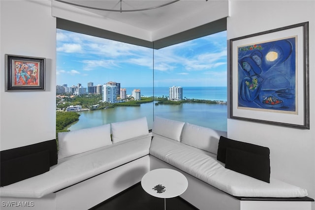 interior space with breakfast area, a water view, and plenty of natural light