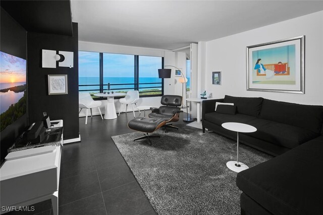 tiled living room featuring a water view