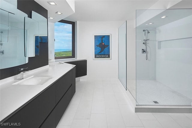 bathroom with tile patterned floors, vanity, and walk in shower