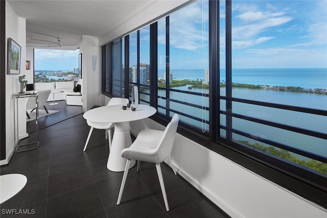 sunroom / solarium with a water view