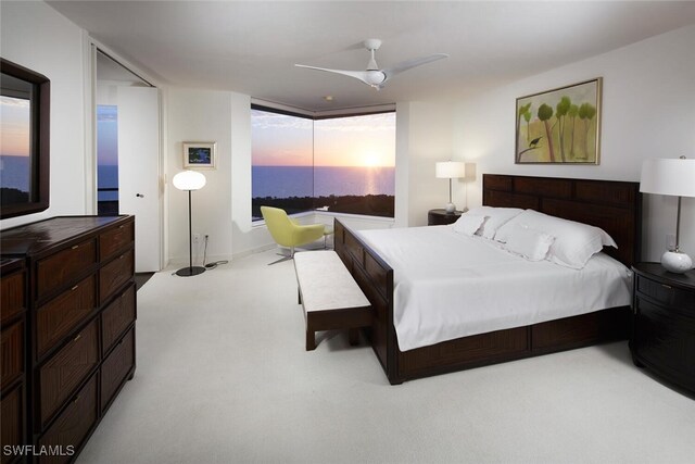 bedroom featuring ceiling fan and light carpet