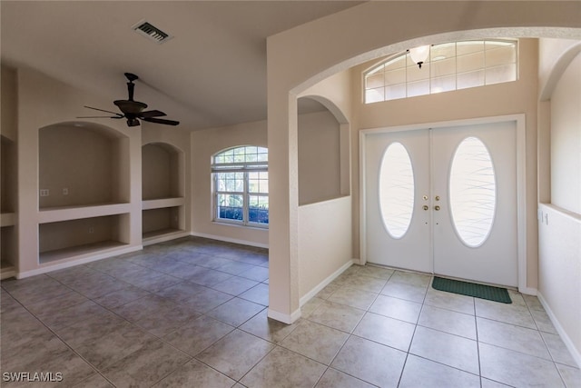 tiled entrance foyer featuring ceiling fan