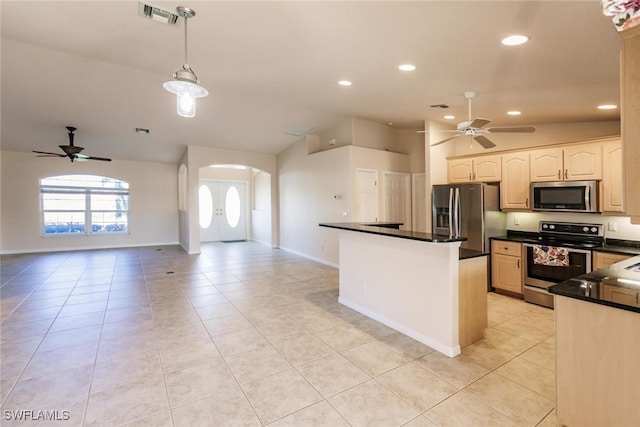 kitchen featuring vaulted ceiling, pendant lighting, light tile patterned floors, appliances with stainless steel finishes, and ceiling fan