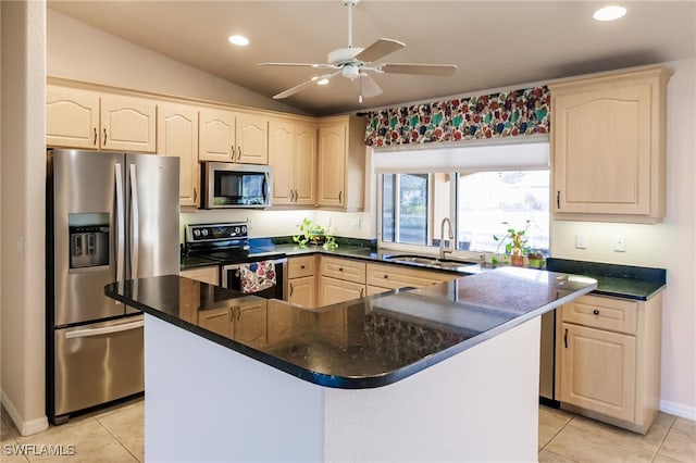 kitchen featuring sink, a kitchen island, stainless steel appliances, lofted ceiling, and light tile patterned floors