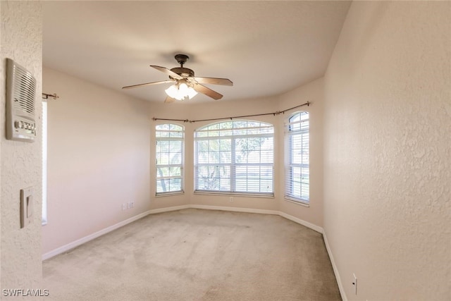 carpeted empty room with ceiling fan