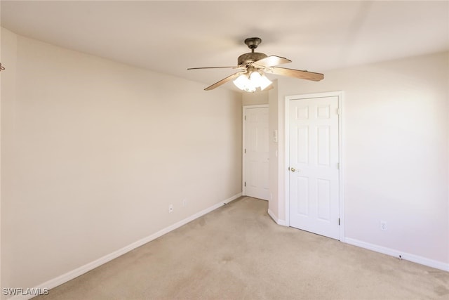 empty room with ceiling fan and light colored carpet