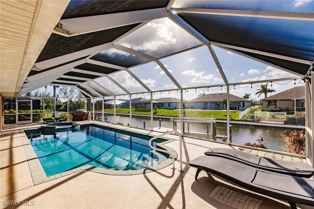 view of swimming pool with a water view, a patio area, and glass enclosure