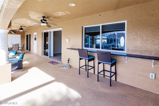 view of patio featuring ceiling fan