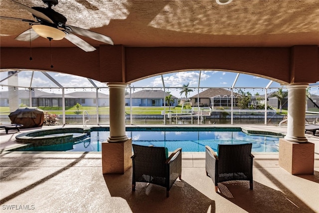 view of pool with an in ground hot tub, glass enclosure, a patio, grilling area, and ceiling fan