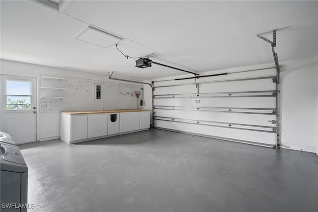 garage with washer / clothes dryer and a garage door opener