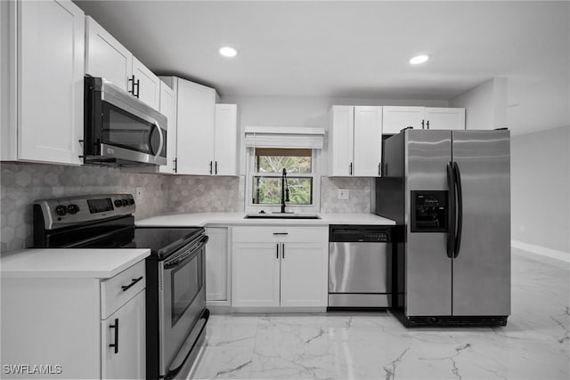 kitchen with white cabinetry, sink, appliances with stainless steel finishes, and tasteful backsplash