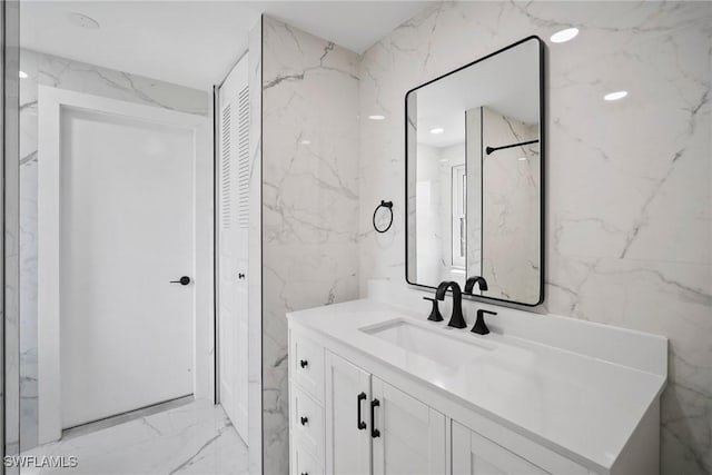 bathroom with vanity and tile walls