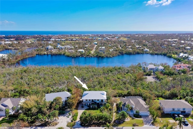 birds eye view of property with a water view