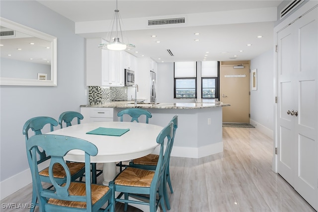 dining area with light hardwood / wood-style floors