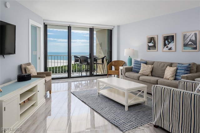 tiled living room with a water view and floor to ceiling windows