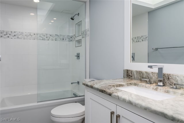 full bathroom with vanity, toilet, and combined bath / shower with glass door