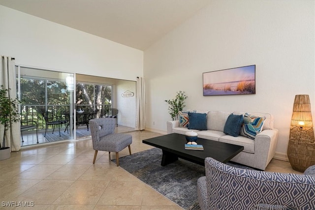 living room featuring high vaulted ceiling and light tile patterned floors