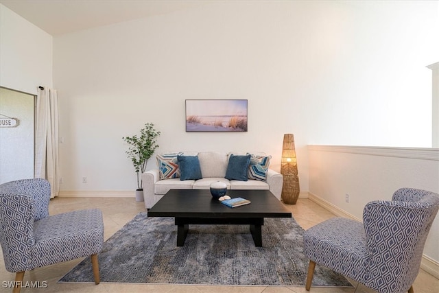 living room featuring lofted ceiling and light tile patterned floors