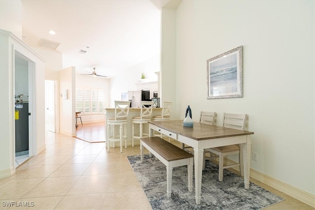 tiled dining area with ceiling fan