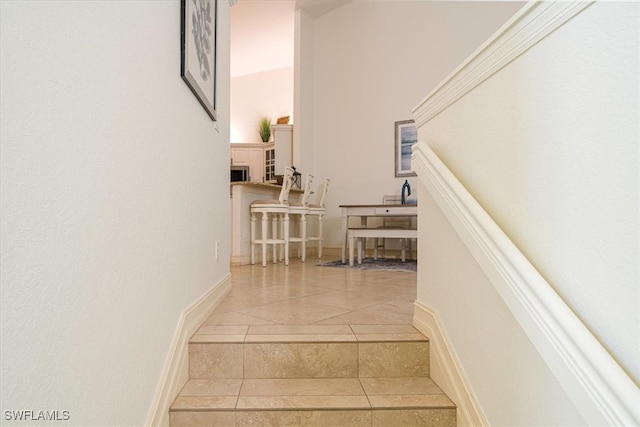 stairs featuring tile patterned floors