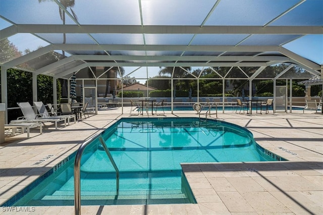 view of pool featuring a patio and glass enclosure