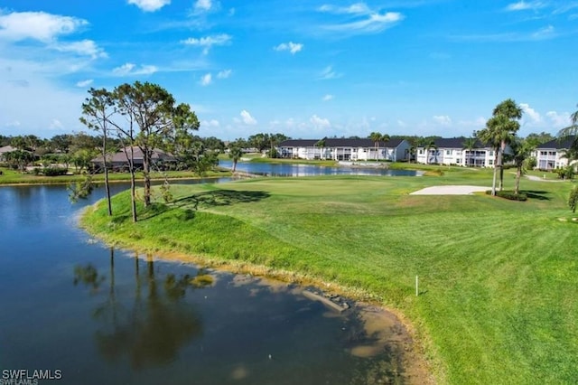 view of home's community featuring a water view and a lawn