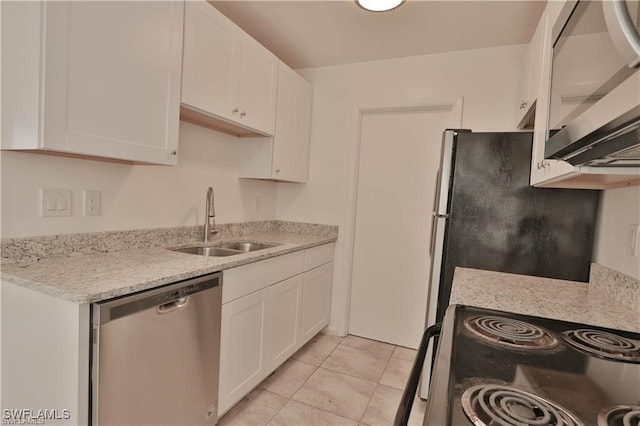 kitchen featuring stainless steel appliances, sink, light tile patterned floors, white cabinetry, and light stone counters