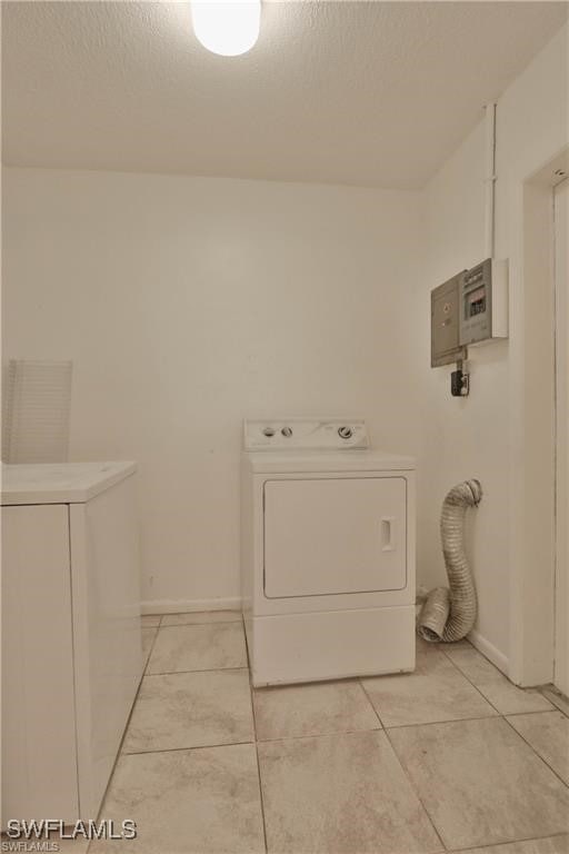 laundry area with washer / clothes dryer, electric panel, and light tile patterned floors