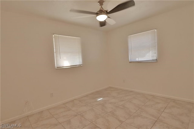 tiled empty room featuring ceiling fan