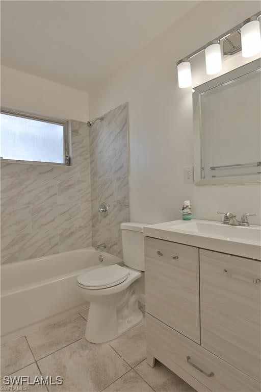 full bathroom with vanity, toilet, tile patterned flooring, and tiled shower / bath