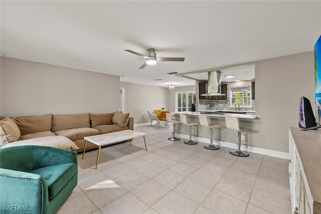 tiled living room with ceiling fan