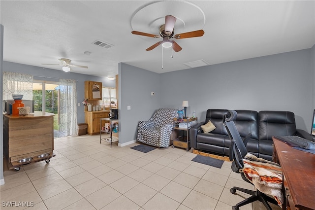 living room with ceiling fan and light tile patterned floors