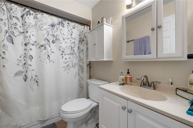 bathroom with vanity, walk in shower, and toilet