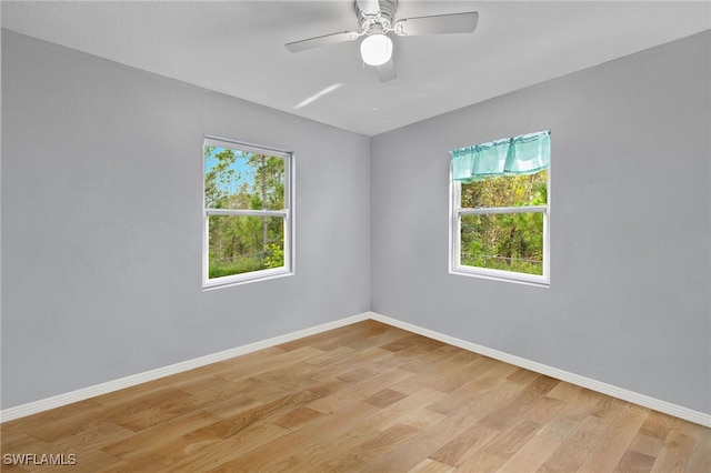 unfurnished room with light hardwood / wood-style flooring and ceiling fan