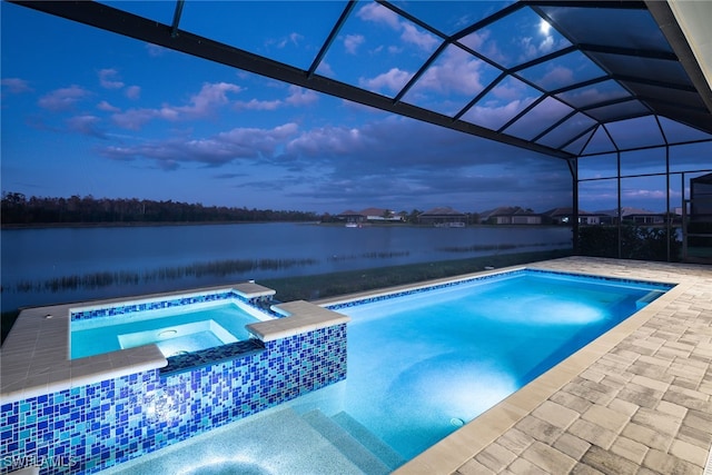 pool at dusk featuring a water view, an in ground hot tub, a lanai, and a patio