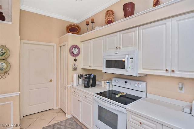 kitchen with crown molding, white cabinets, light tile patterned floors, and white appliances