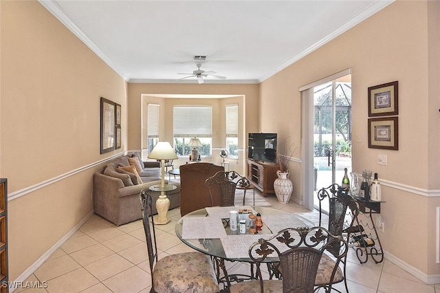 interior space with ornamental molding and ceiling fan