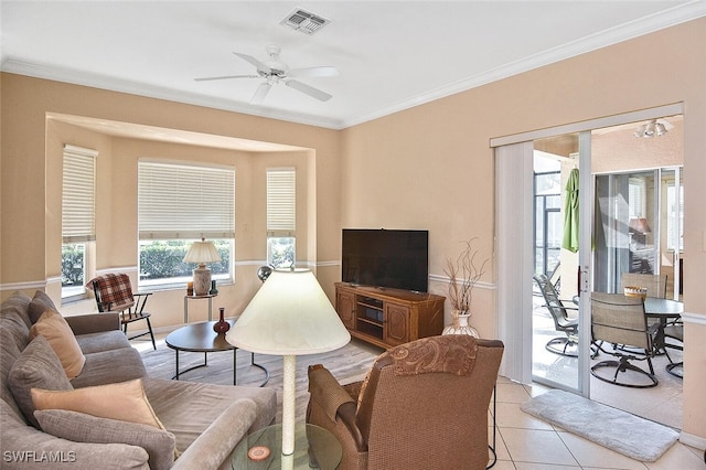 living room with ornamental molding, ceiling fan, and light tile patterned floors