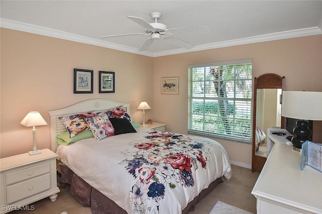 carpeted bedroom with ceiling fan and crown molding