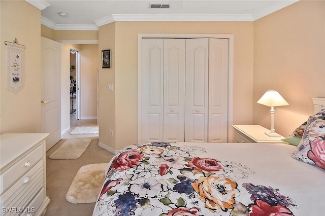 carpeted bedroom with crown molding and a closet