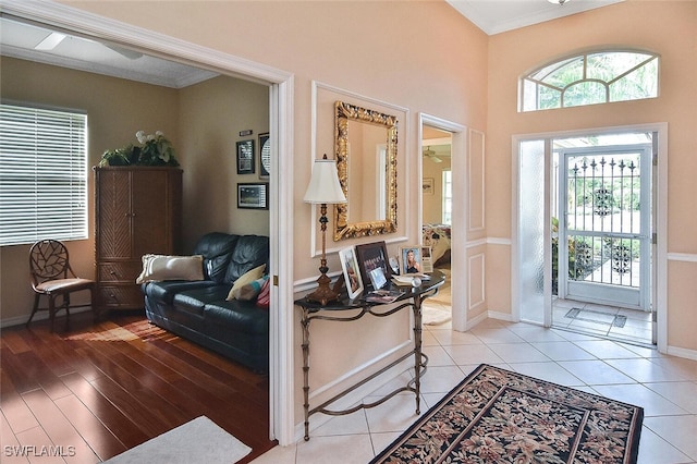 foyer featuring ornamental molding and light hardwood / wood-style flooring