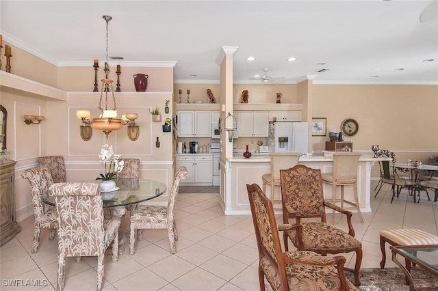 dining room featuring ornamental molding, ceiling fan with notable chandelier, and light tile patterned floors