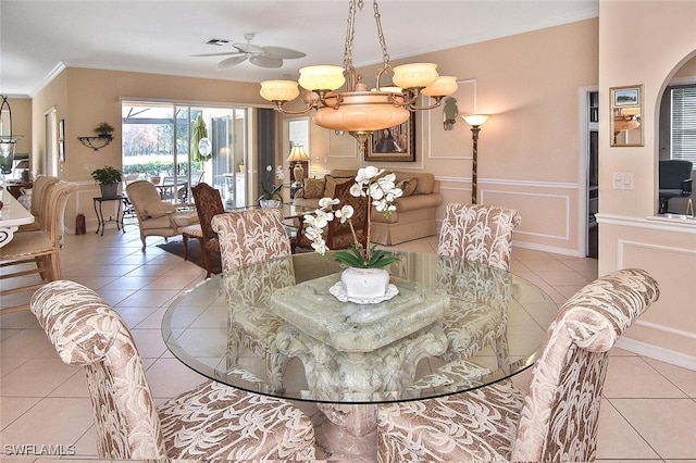 tiled dining space with crown molding and ceiling fan with notable chandelier