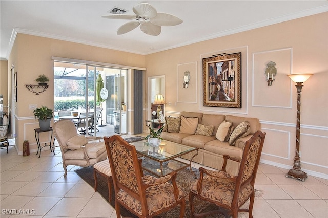 tiled living room with ceiling fan and ornamental molding