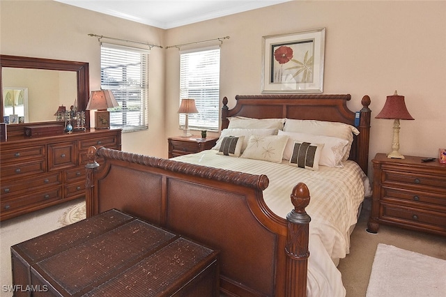 bedroom with light carpet and crown molding