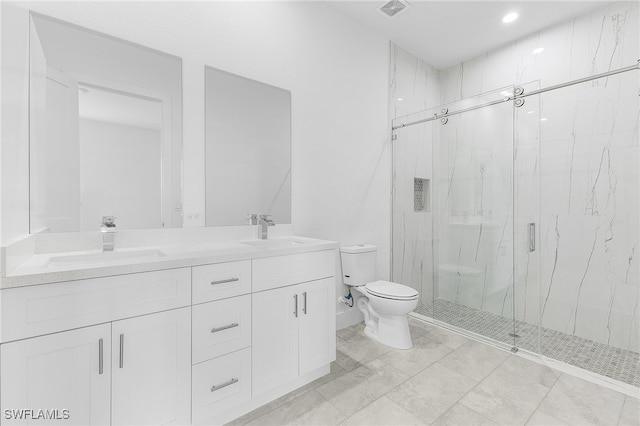 bathroom with a shower with door, vanity, and toilet